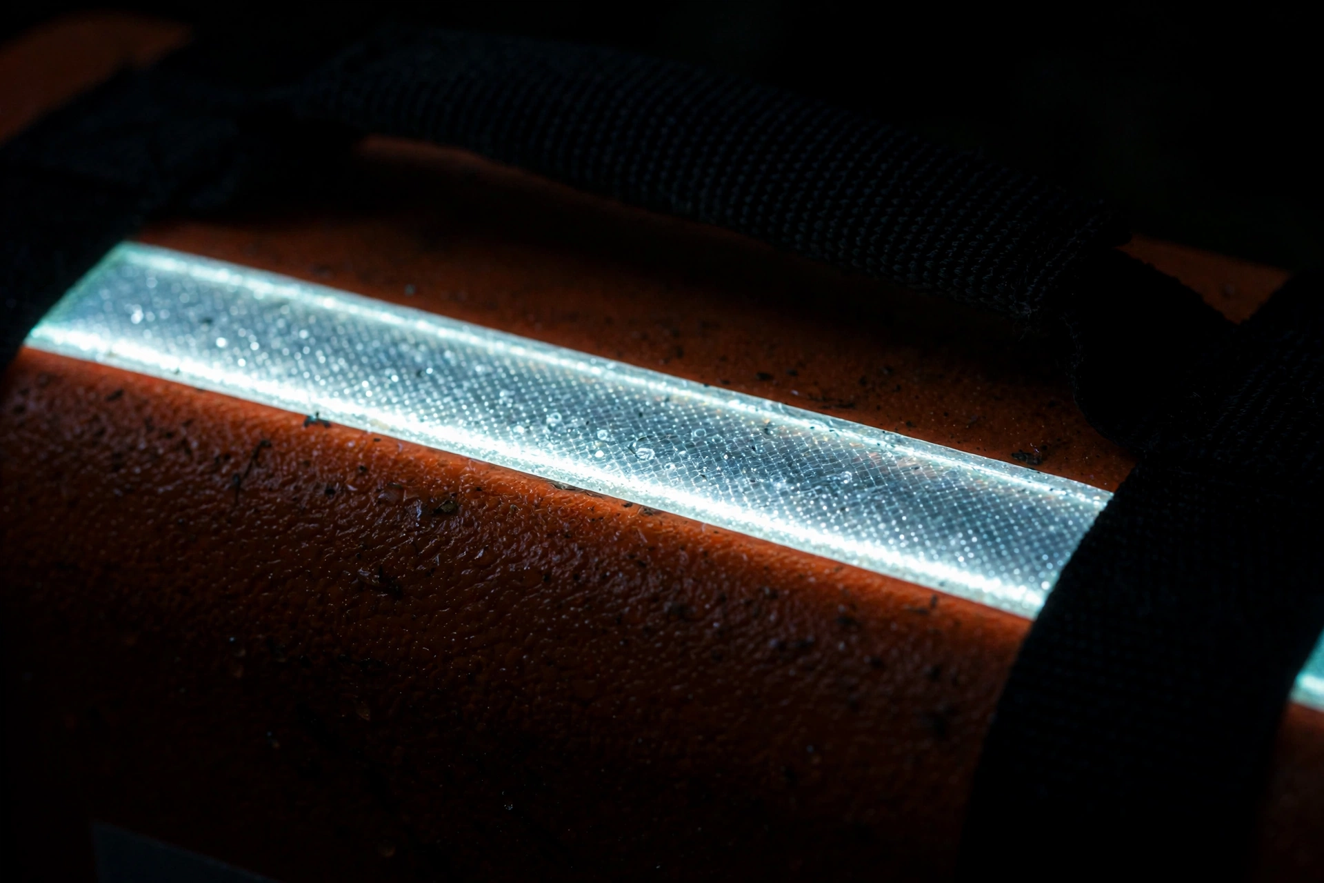 Silver reflective strip glowing in the dark on the orange EVA first aid case